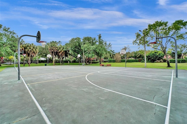 view of basketball court with a lawn