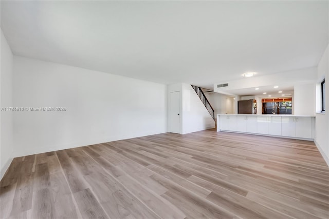 unfurnished living room featuring light hardwood / wood-style flooring