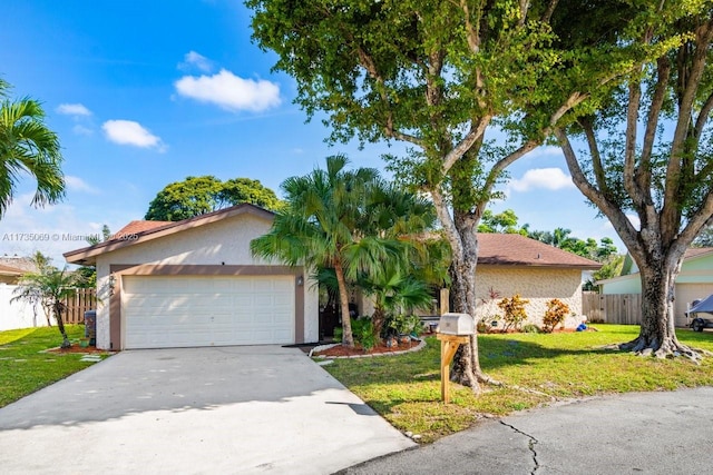 ranch-style house with a garage and a front lawn