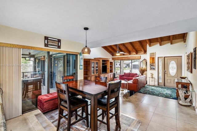 dining space featuring ceiling fan, light tile patterned floors, lofted ceiling with beams, and wooden ceiling