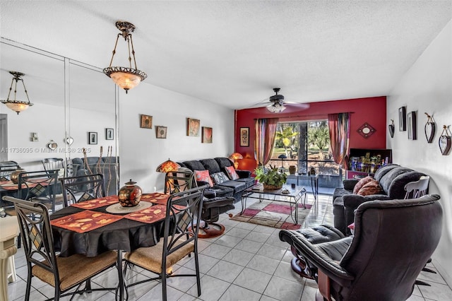 living room with ceiling fan, a textured ceiling, and light tile patterned floors