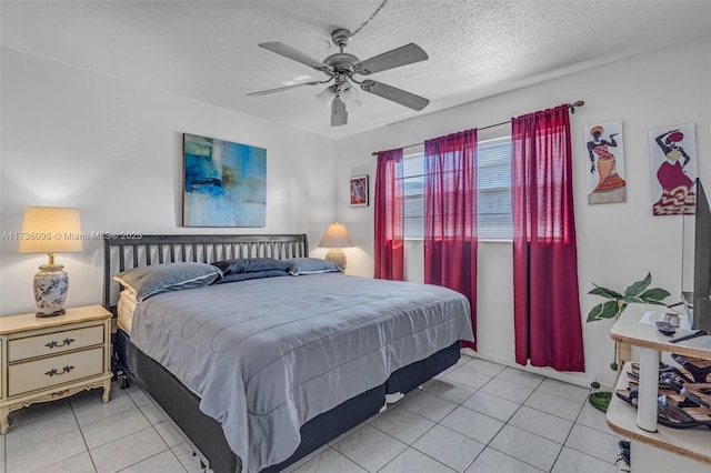 tiled bedroom featuring ceiling fan and a textured ceiling