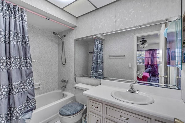 full bathroom with shower / bathtub combination with curtain, vanity, and toilet