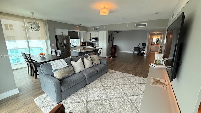 living room with sink, a wealth of natural light, and light hardwood / wood-style floors