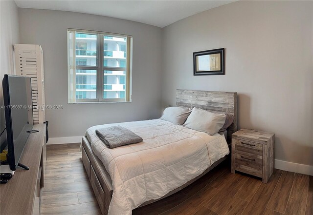 bedroom featuring dark hardwood / wood-style flooring