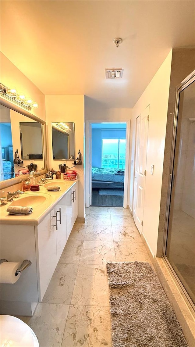 bathroom featuring vanity and a shower with shower door