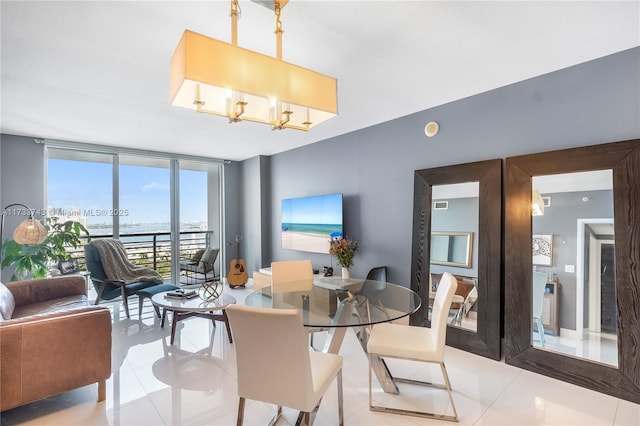 tiled dining area with expansive windows and a chandelier