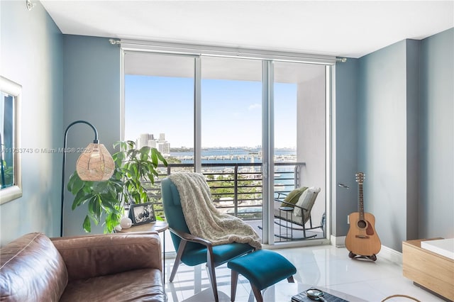 living area with light tile patterned floors and floor to ceiling windows