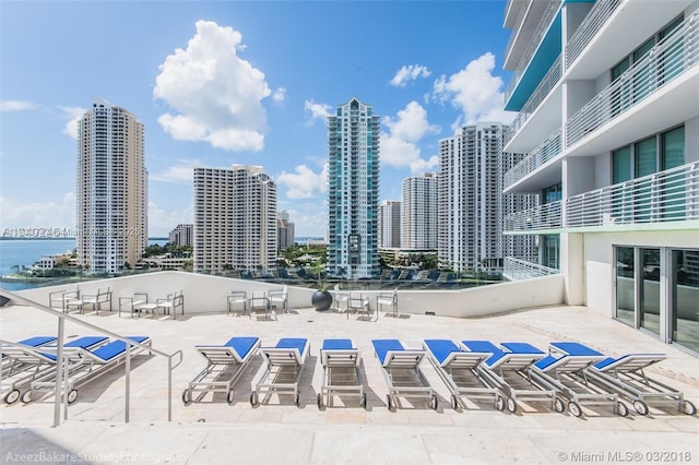 view of pool with a water view and a patio area