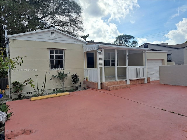 view of front facade with a garage and a patio area