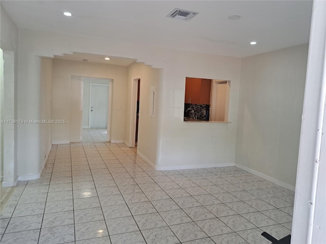 tiled spare room featuring sink