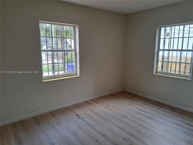 spare room featuring light hardwood / wood-style flooring