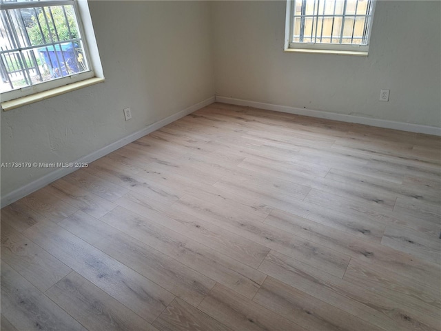 empty room with light hardwood / wood-style floors