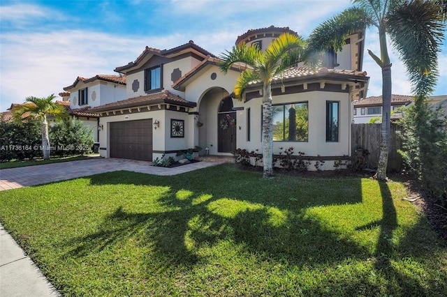 mediterranean / spanish-style house featuring a garage and a front yard