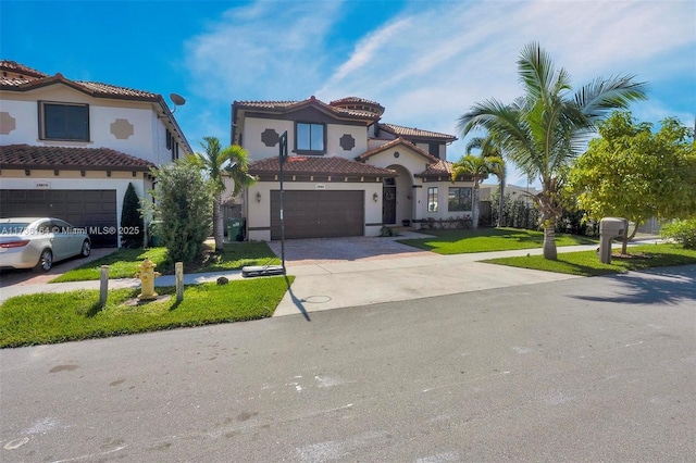 mediterranean / spanish-style house featuring a garage and a front yard