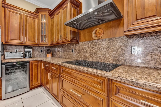 kitchen with brown cabinetry, wine cooler, black electric cooktop, extractor fan, and crown molding