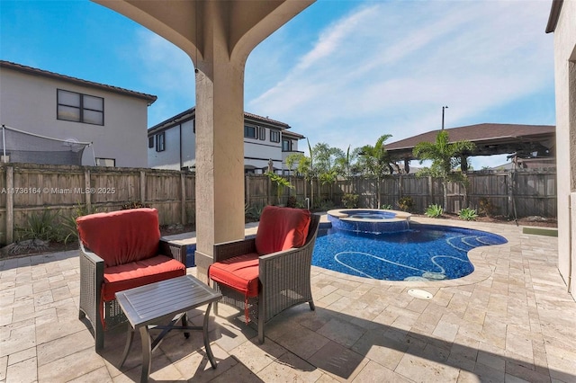 view of pool featuring an in ground hot tub and a patio area