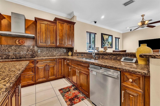 kitchen with sink, dishwasher, ceiling fan, dark stone countertops, and wall chimney exhaust hood