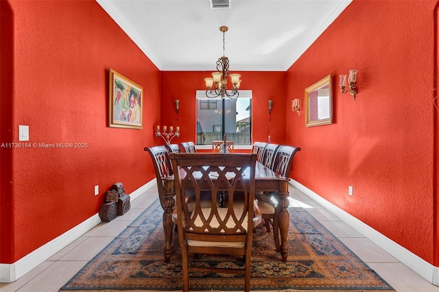 dining space with tile patterned flooring, a chandelier, baseboards, and ornamental molding