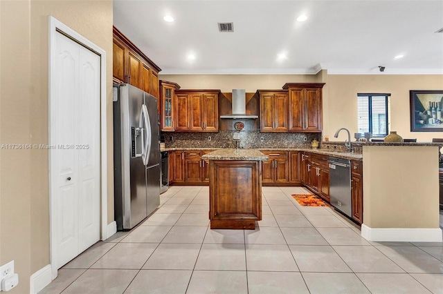 kitchen featuring appliances with stainless steel finishes, a center island, light stone countertops, kitchen peninsula, and wall chimney exhaust hood