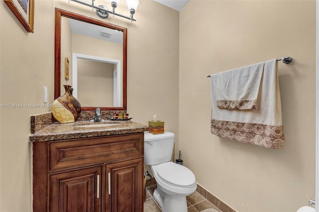 bathroom with visible vents, baseboards, toilet, tile patterned flooring, and vanity