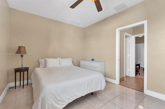 bedroom featuring light tile patterned floors, a ceiling fan, visible vents, and baseboards