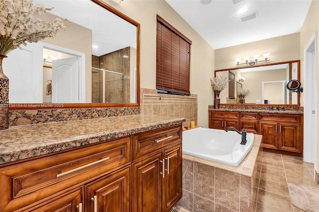 bathroom with vanity, tile patterned floors, and plus walk in shower