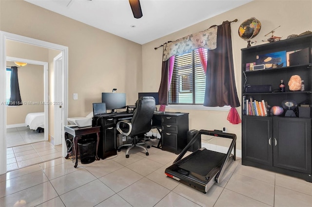 home office featuring a ceiling fan, baseboards, and tile patterned floors