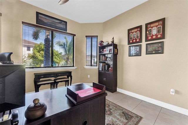 home office with a healthy amount of sunlight, light tile patterned flooring, and baseboards