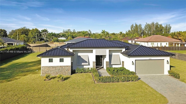 view of front of home with a garage and a front yard