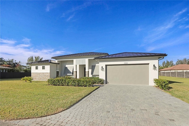 view of front of home featuring a garage and a front lawn