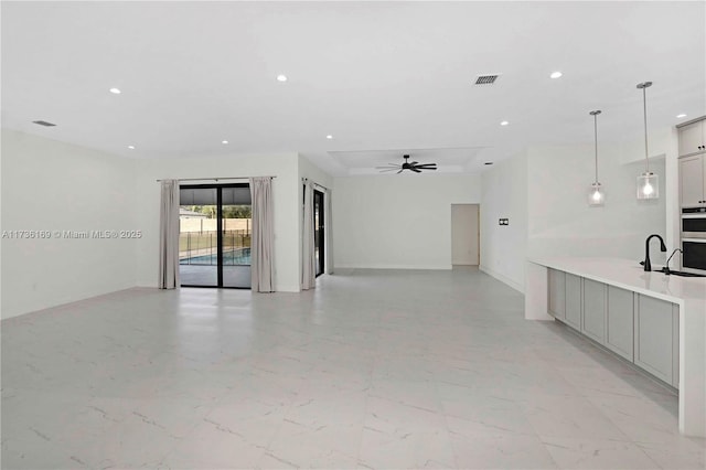 spare room featuring sink and ceiling fan