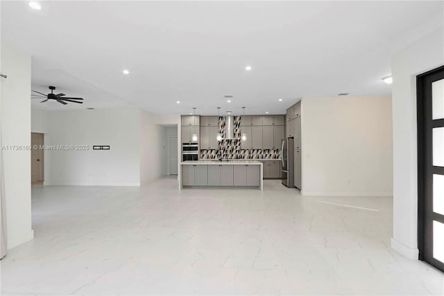 unfurnished living room featuring ceiling fan