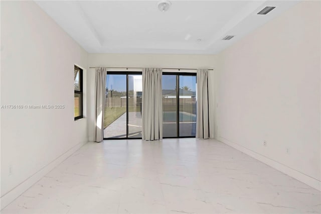 unfurnished room with a raised ceiling