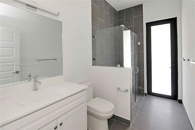 bathroom with vanity, an enclosed shower, tile patterned floors, and toilet