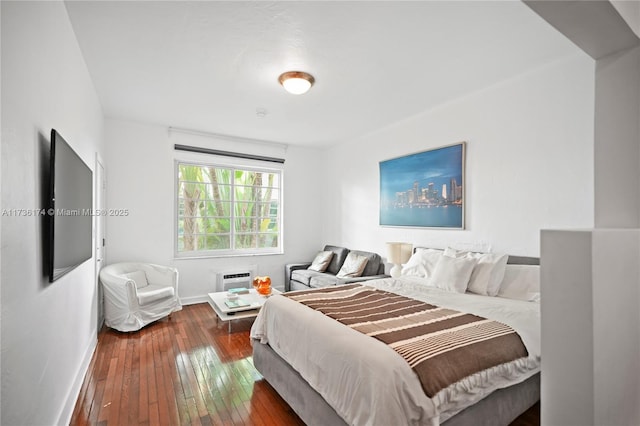 bedroom with dark hardwood / wood-style floors