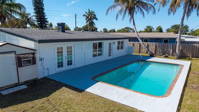 view of pool with a lawn and a patio area