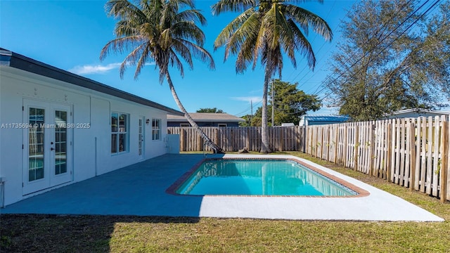 view of swimming pool featuring a patio and french doors