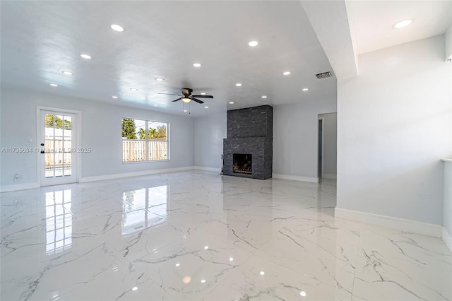 unfurnished living room featuring ceiling fan and a fireplace