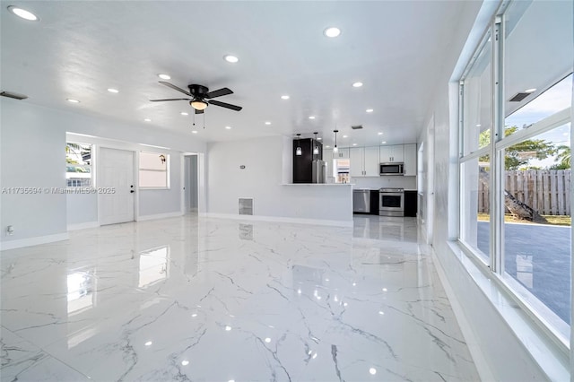 unfurnished living room with ceiling fan