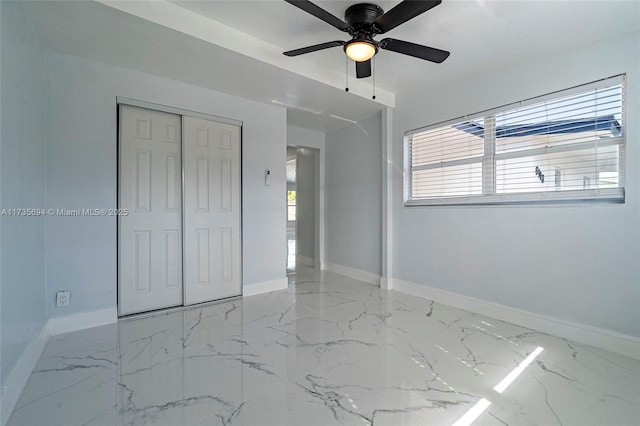 unfurnished bedroom featuring ceiling fan, a closet, and multiple windows