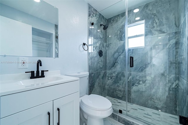 bathroom featuring walk in shower, vanity, and toilet