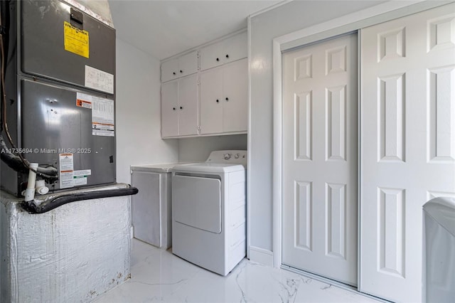 laundry room with cabinets, separate washer and dryer, and heating unit