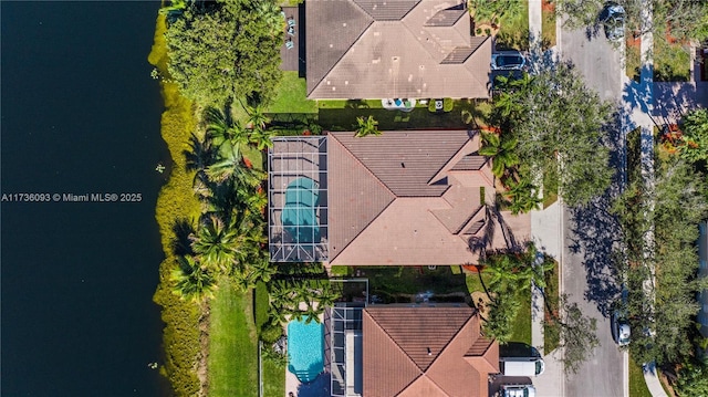 birds eye view of property with a water view