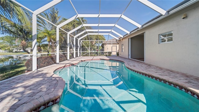 view of pool featuring a lanai, a patio area, and a water view