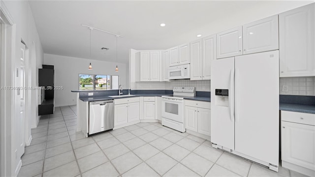 kitchen featuring light tile patterned flooring, white cabinetry, sink, backsplash, and white appliances