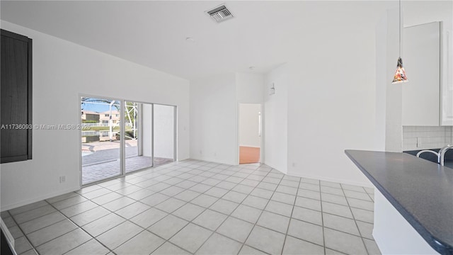 unfurnished living room featuring light tile patterned flooring