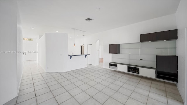 unfurnished living room featuring light tile patterned flooring