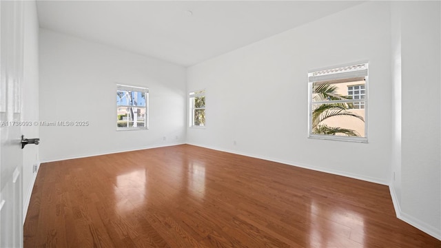 empty room with dark wood-type flooring