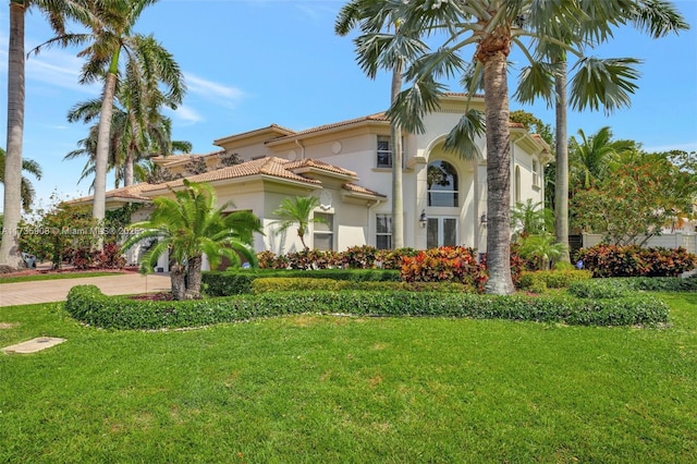 mediterranean / spanish-style house featuring a front lawn